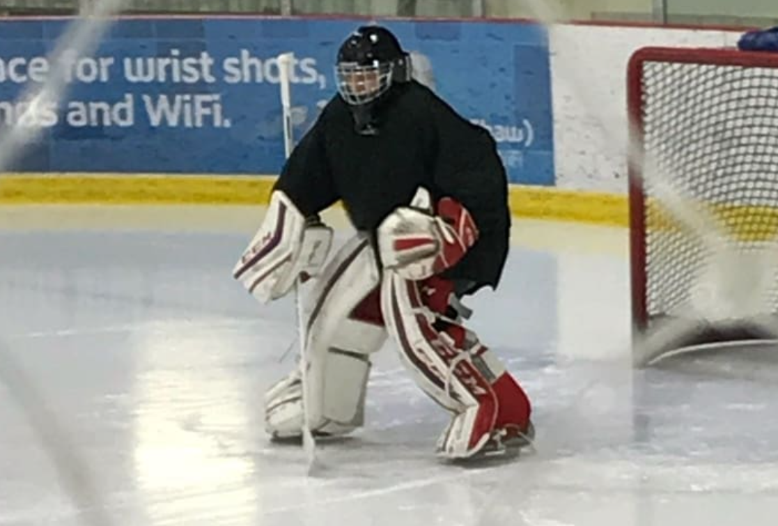 Tim facing down a hockey opponent